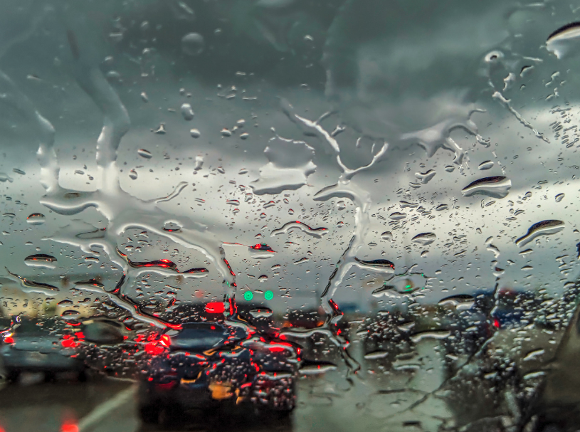 Traffic seen through a rain-covered windshield during a spring storm in Bentonville, Arkansas
